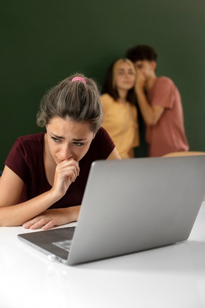 Medium shot sad girl with laptop