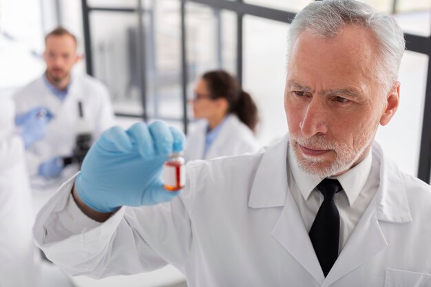 Medium shot scientist holding vial