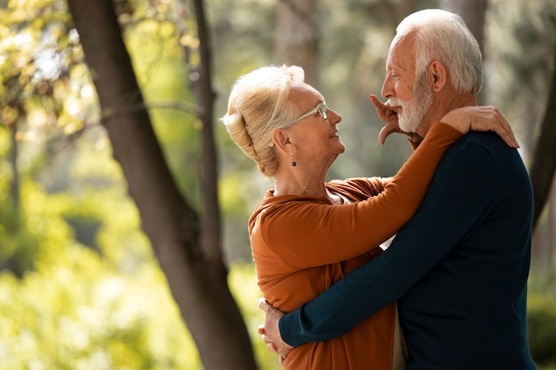 Free photo medium shot senior couple holding each other