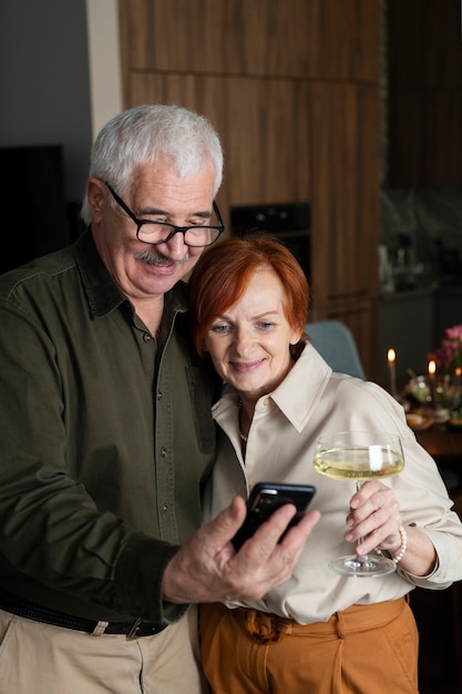 Medium shot senior couple taking selfie