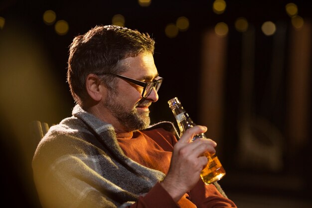 Medium shot senior man holding bottle