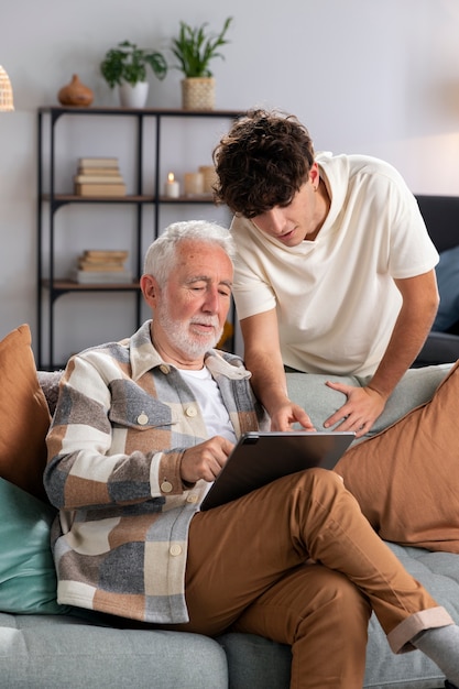 Medium shot senior man holding tablet