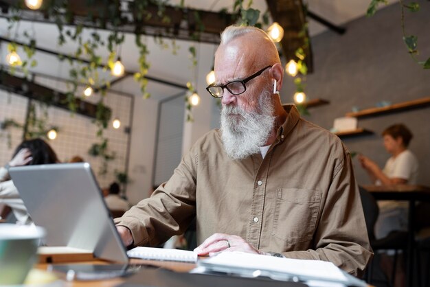 Medium shot senior man studying