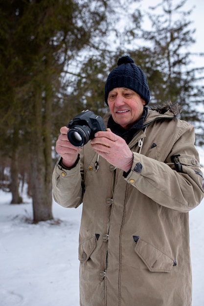 Medium shot senior man taking photos