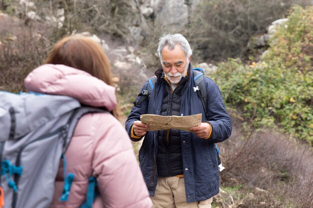 Medium shot senior people hiking together