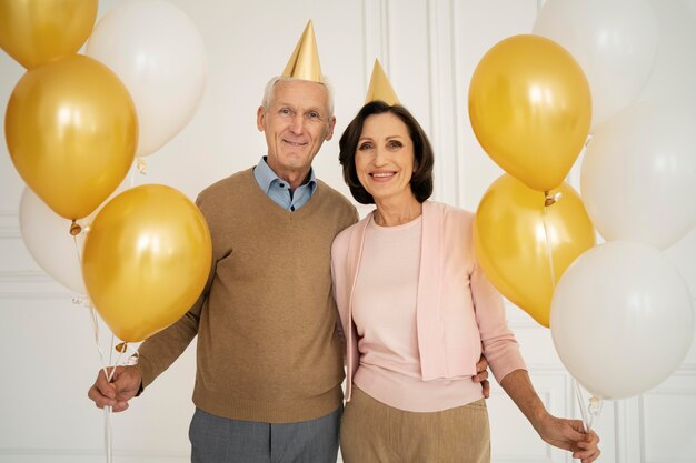 Medium shot senior people with balloons