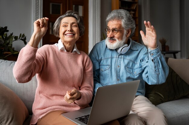 Medium shot senior people with laptop