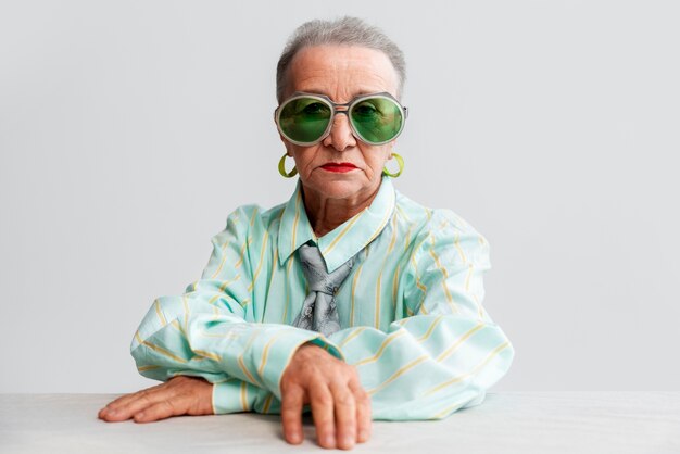 Free photo medium shot senior woman posing in studio