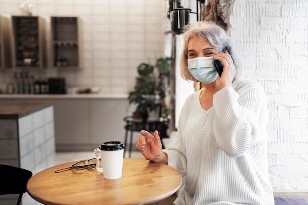 Medium shot senior woman talking on phone