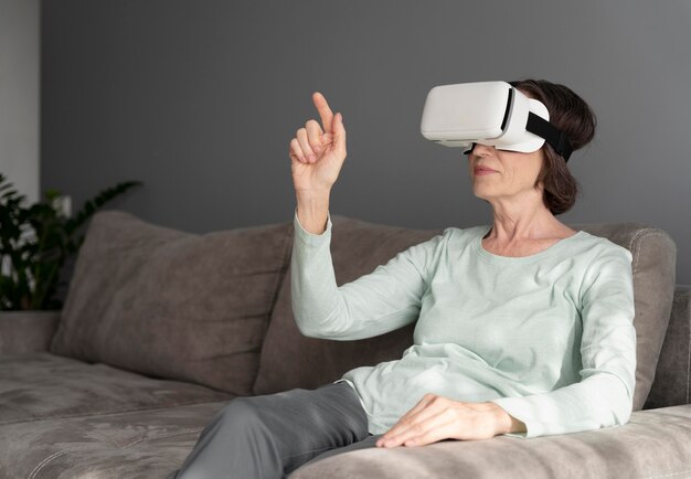 Medium shot senior woman with vr glasses