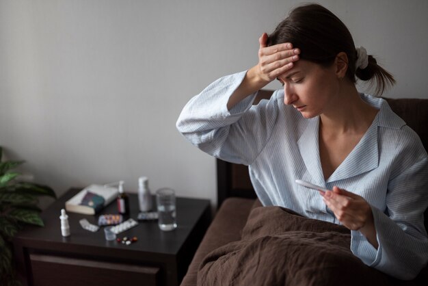 Medium shot sick woman with fever