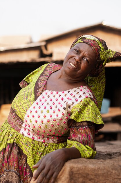 Medium shot smiley african woman outside