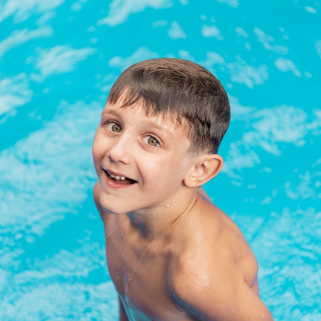 Medium shot smiley boy in pool