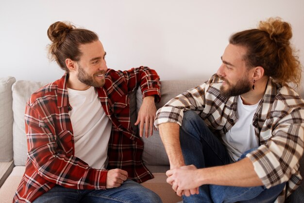 Medium shot smiley brothers sitting on couch