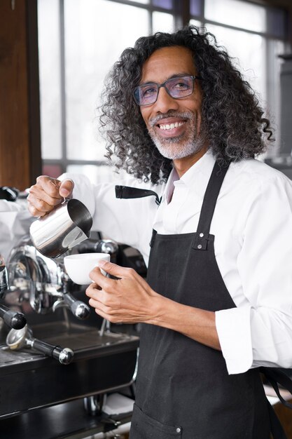 Medium shot smiley business owner making coffee