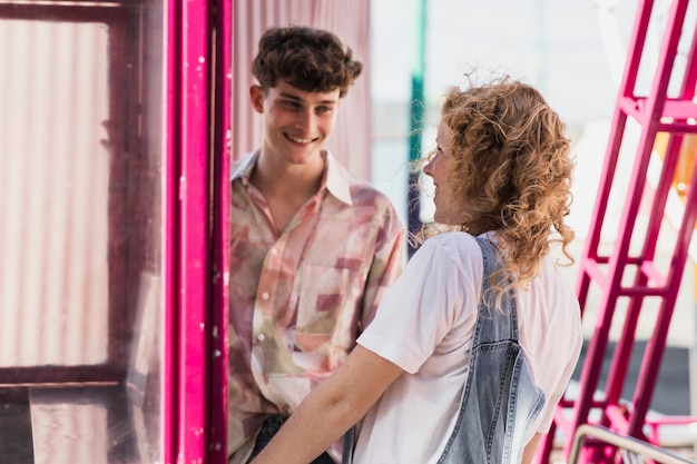 Free Photo medium shot smiley couple at funfair