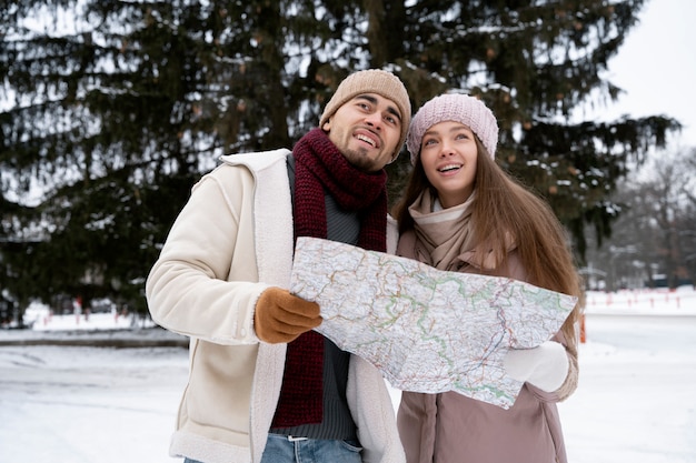 Medium shot smiley couple holding map