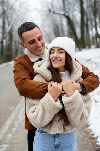 Medium shot smiley couple outdoors