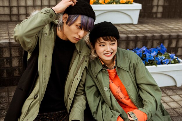 Medium shot smiley couple sitting on stairs