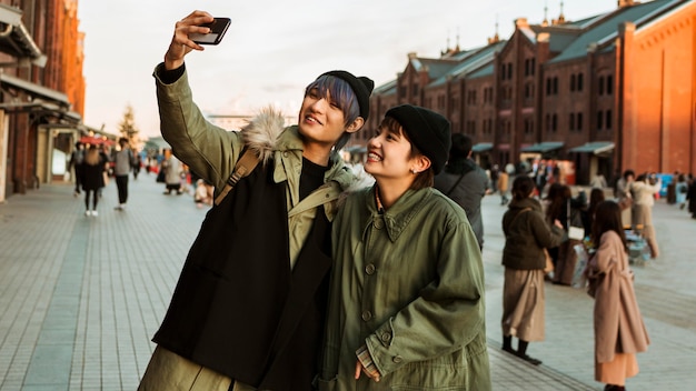 Medium shot smiley couple taking selfie