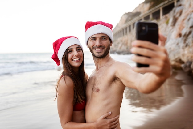 Medium shot smiley couple taking selfie