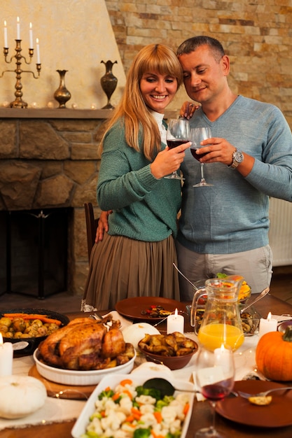 Medium shot smiley couple toasting