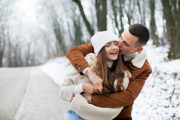 Free Photo medium shot smiley couple winter time