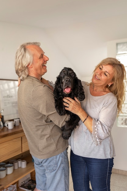 Medium shot smiley couple with dog