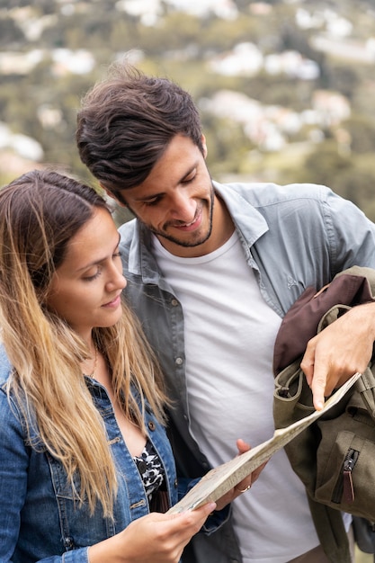 Medium shot smiley couple with map