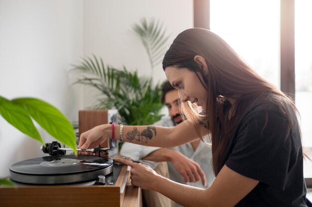 Medium shot smiley couple with vinyl disc