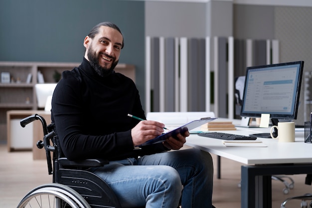 Free Photo medium shot smiley disabled man at work