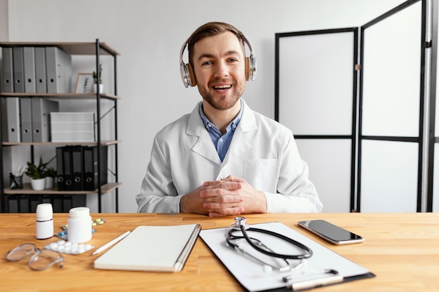 Medium shot smiley doctor at desk