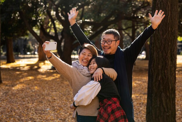 Medium shot smiley family in nature