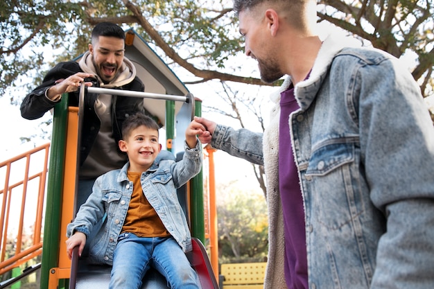 Medium shot smiley family in park