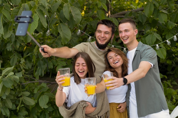 Medium shot smiley friends taking selfie