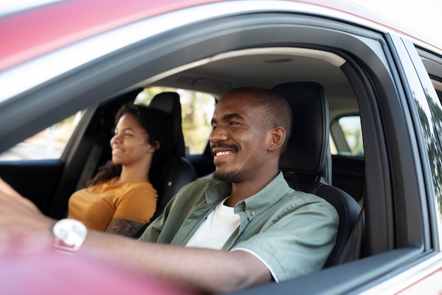 Medium shot smiley friends traveling by car