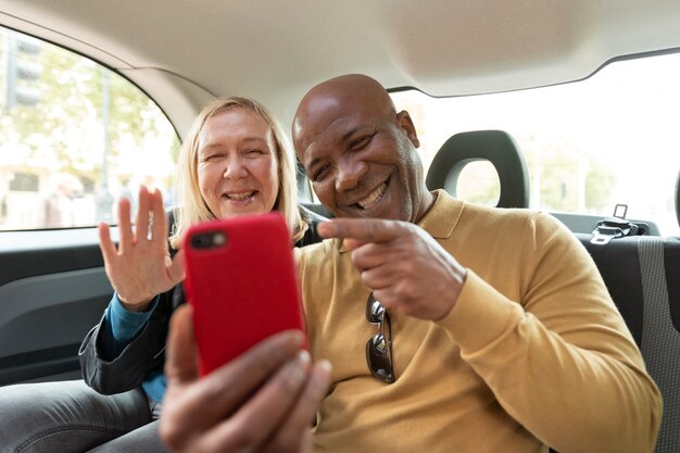 Medium shot smiley friends with smartphone