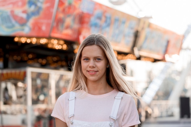 Medium shot smiley girl at funfair