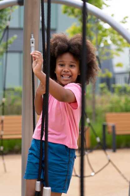 Medium shot smiley girl outdoors