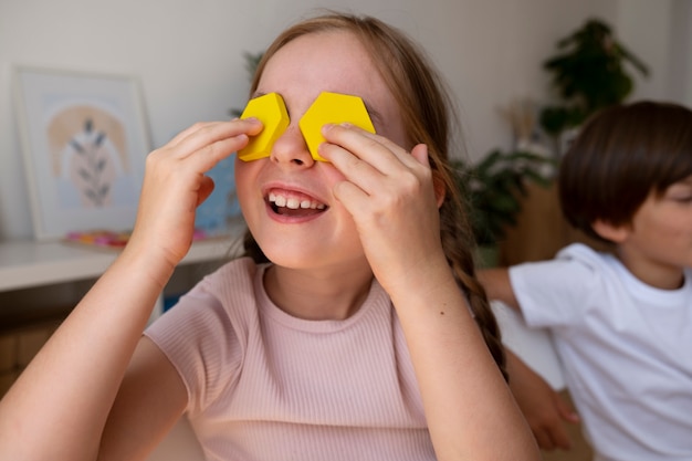 Free Photo medium shot smiley girl with puzzle pieces