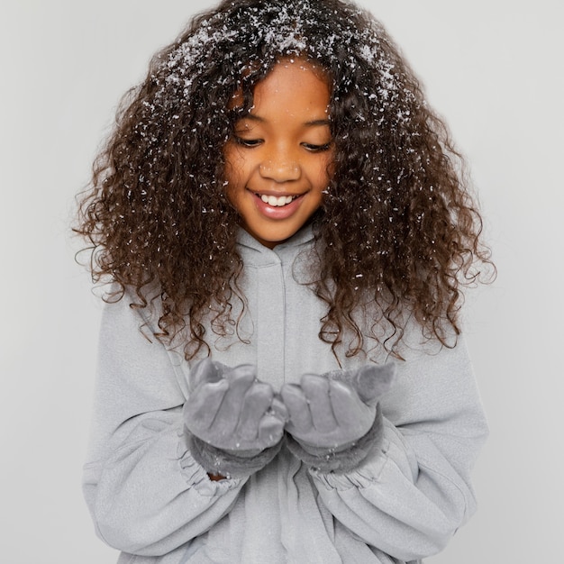 Medium shot smiley girl with snow