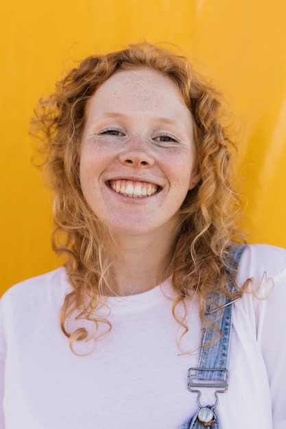 Medium shot smiley girl with yellow background