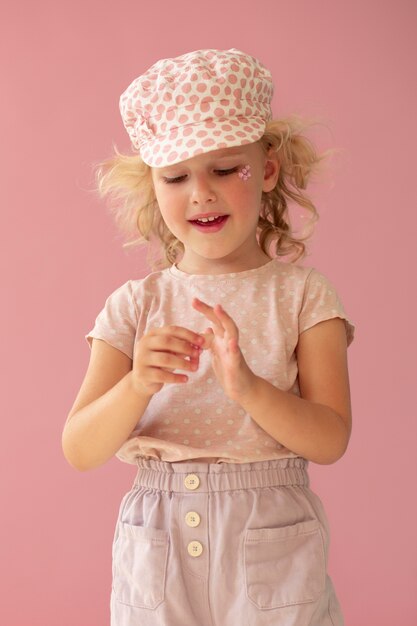 Medium shot smiley kid wearing hat