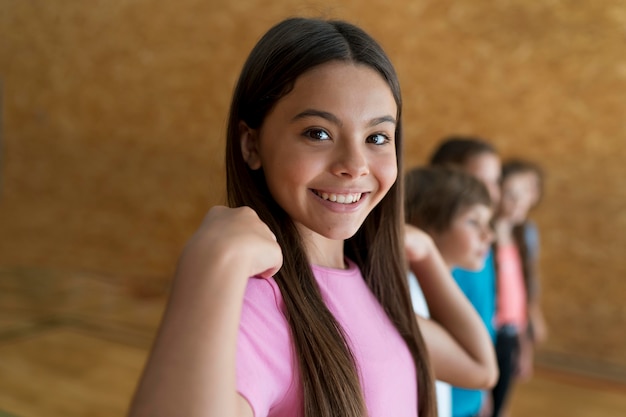 Medium shot smiley kids in school gym