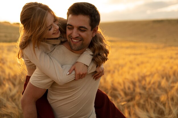 Medium shot smiley man carrying woman