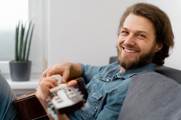 Medium shot smiley man on couch