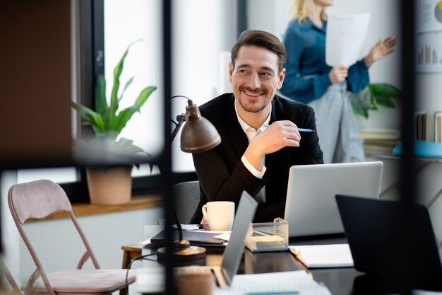 Medium shot smiley man at desk