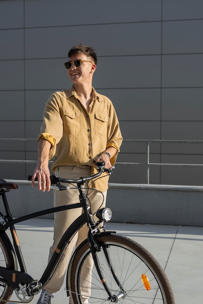 Medium shot smiley man holding bike