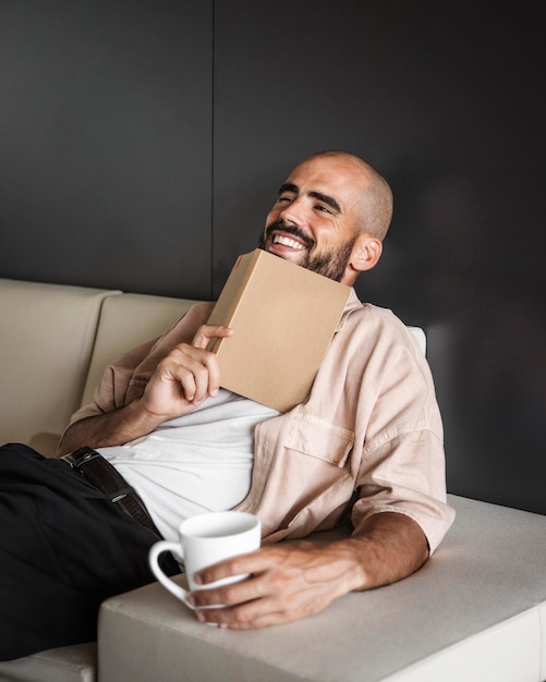 Medium shot smiley man holding book