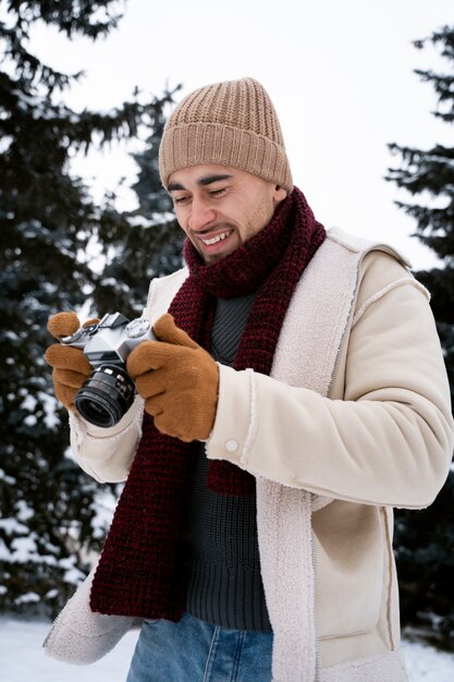 Medium shot smiley man holding camera